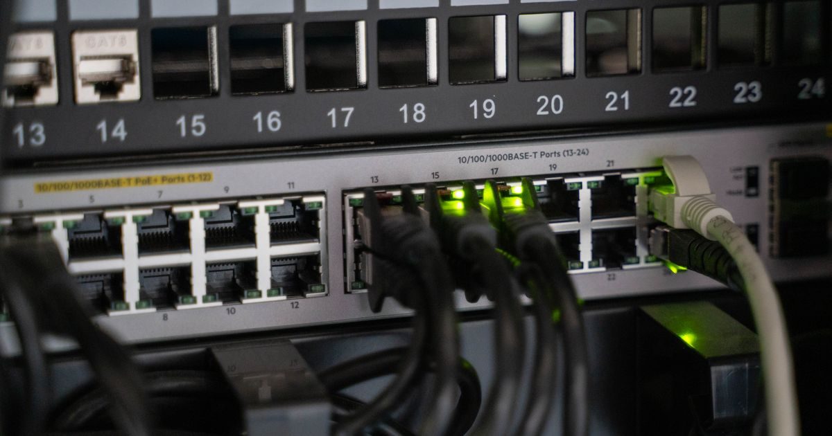 Networking equipment with connected cables, showcasing modern technology infrastructure.