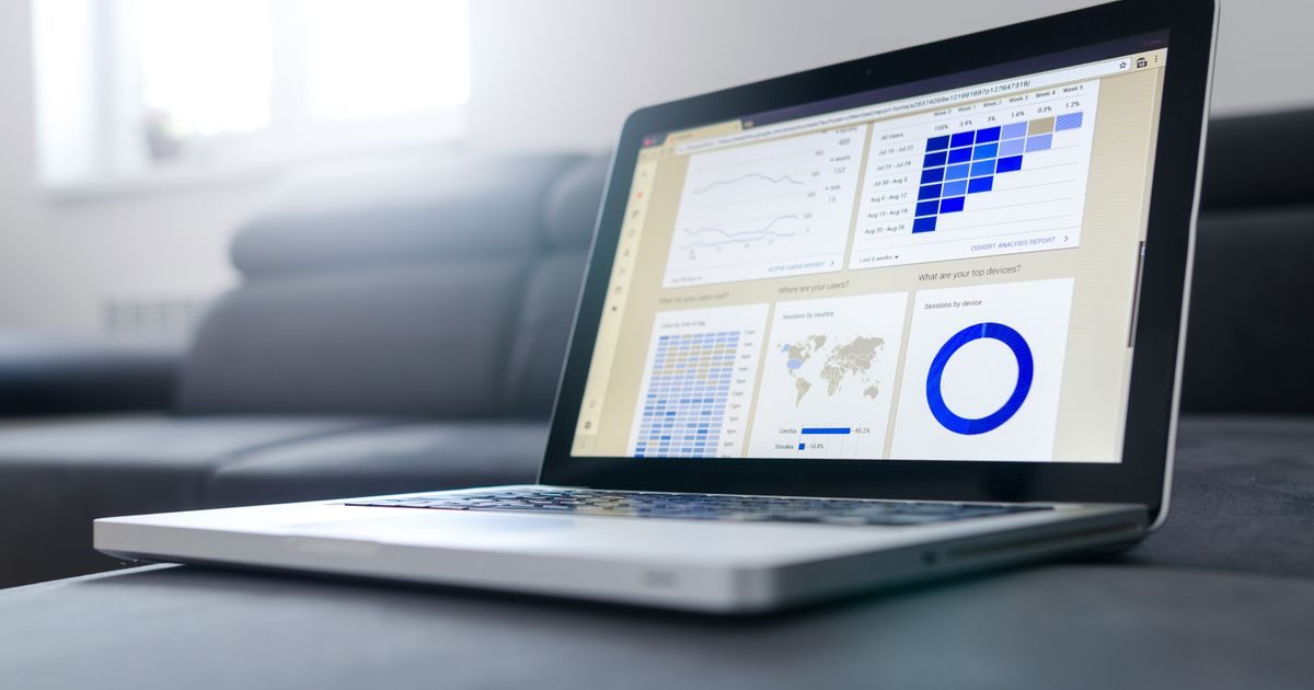 Sleek laptop showcasing data analytics and graphs on the screen in a bright room.