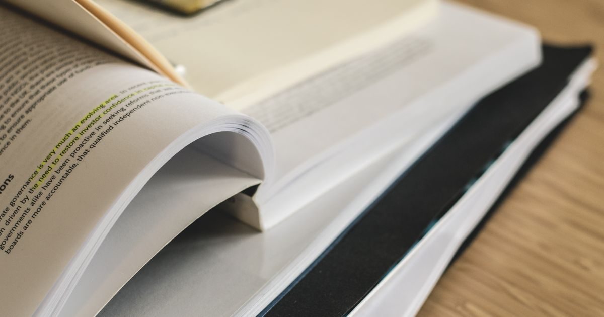 A pile of open books on a table, ideal for study and research themes.