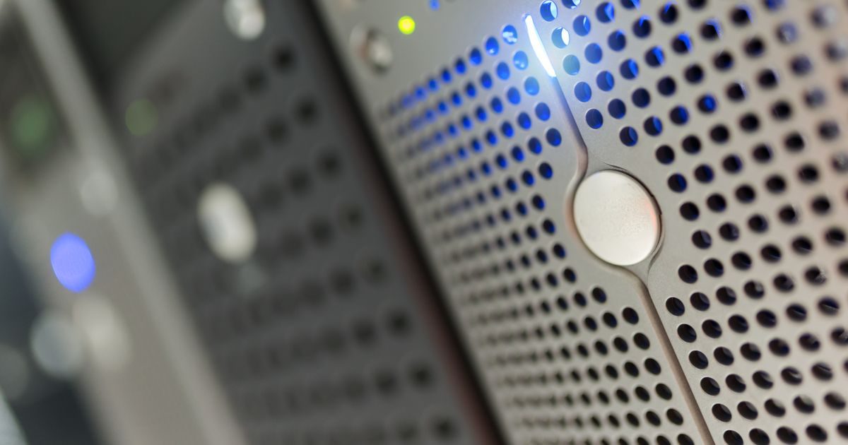 Focused detail of a modern server rack with blue LED indicators in a data center.